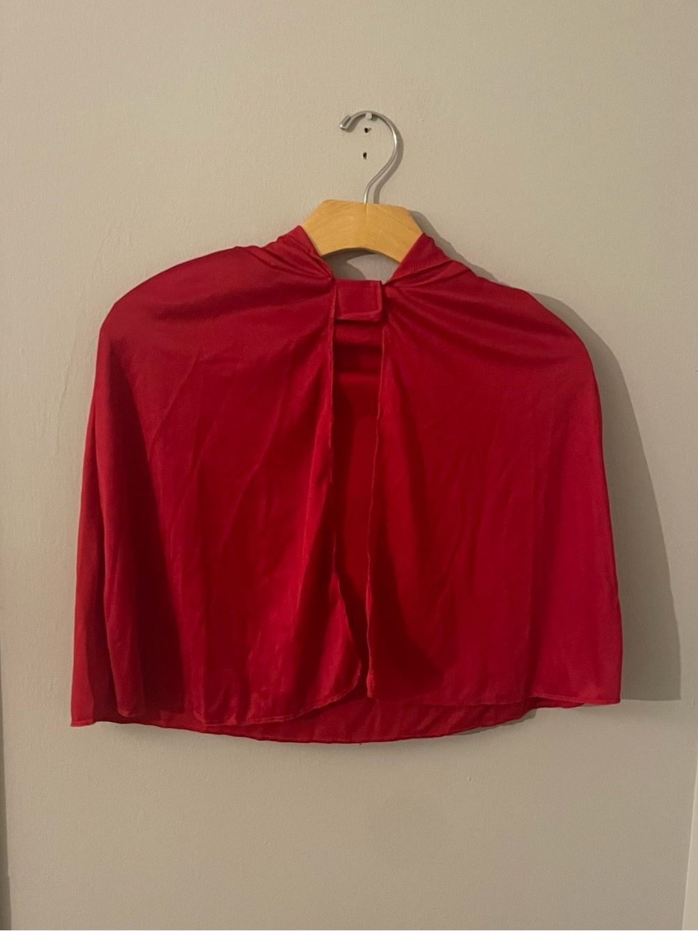Red hooded capelet with velcro neck closure